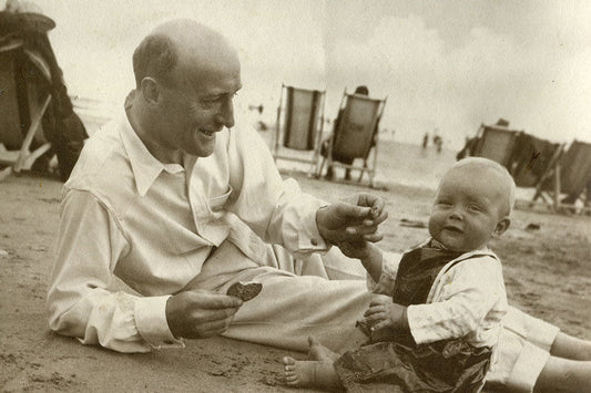 Harold Budd sat on the beach with his child