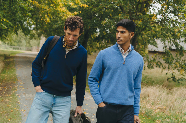 Two male models wearing zip up jumpers