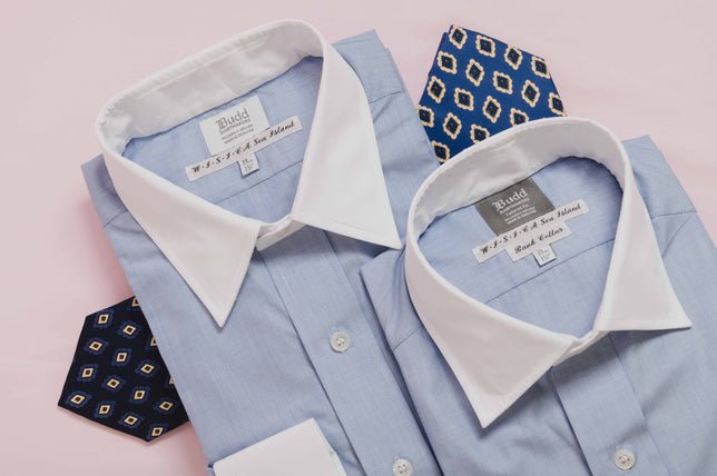 Blue shirts with white collar on pink background