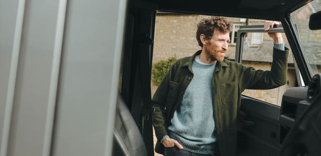 Man wearing olive overshirt chore jacket with blue jumper