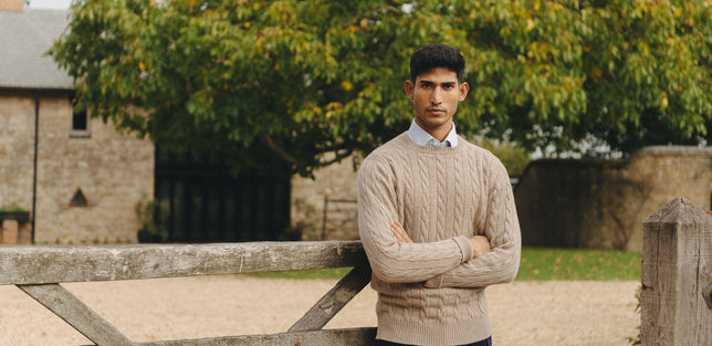 AW25 Male model wearing cable knit crew neck jumper outside