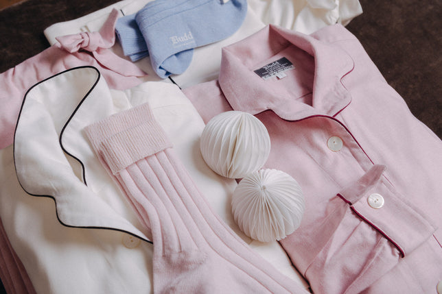 Selection of laids pyjamas and socks in pink blue and white laid out
