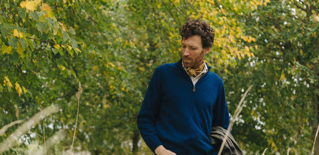 Man in woodland wearing zip up knitted sweater