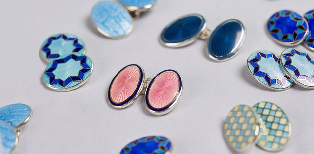 Selection of coloured cufflinks on pale grey background