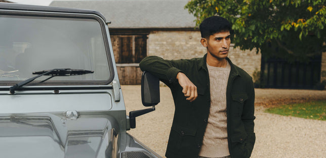 Man stood outside by Defender wearing Winter safari shirt in dark green