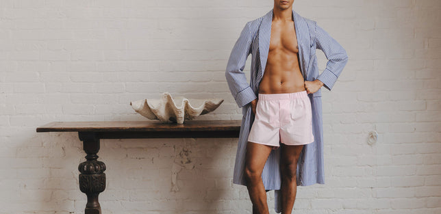 Man wearing pink boxers with striped blue dressing gown