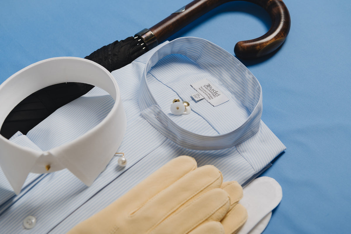 White shirt with collar, tie, glasses, and gloves on a blue background