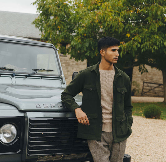 Man standing next to a Land Rover vehicle outdoors
