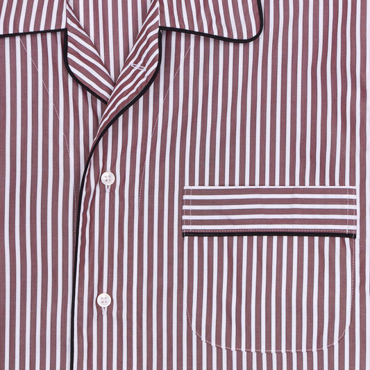 Close-up of a maroon and white striped night shirt with a pocket on a white background