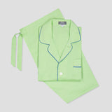 Green pajama set with blue piping on a light gray background