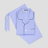 Light blue pajama set with black piping on a light gray background