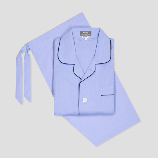 Light blue pajama set with black piping on a light gray background
