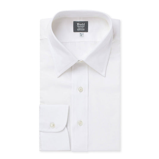 A folded white long-sleeve dress shirt with a pointed collar, button-down front, and a single chest pocket, shown on a plain white background. The inner neck label reads 'Budd'.