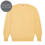 Yellow sweater on a white background with 'Online & In-Store' text.