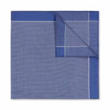 Folded blue fabric with a grid pattern on a white background