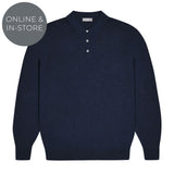 Navy sweater with button details on a white background with tag reading online and in-store