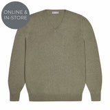 Green sweater on a white background with 'Online & In-Store' label.