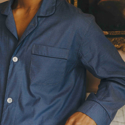 Close-up of a person wearing a blue textured pyjama  with a blurred background