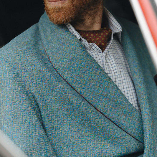 Detail shot of male model wearing a blue herringbone tweed dressing gown1qa