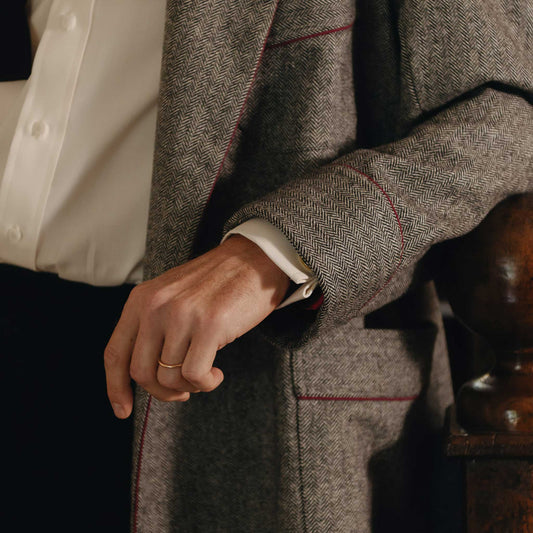 Close up cuff shot of herringbone dressing gown in grey