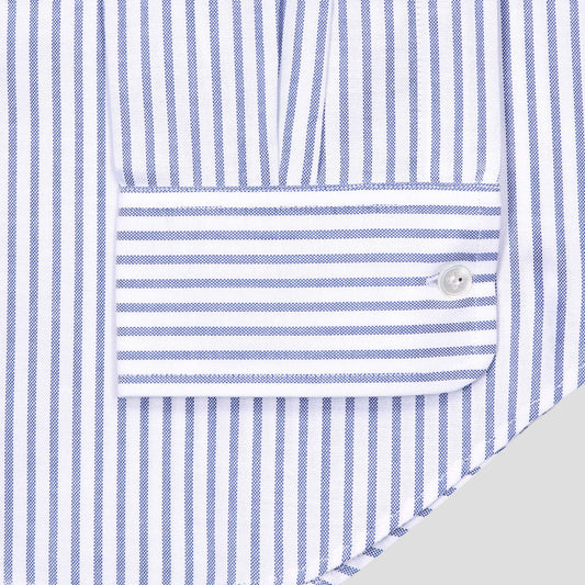 Close-up of a blue and white striped shirt cuff with a single button closure, showing the fabric texture and pattern.