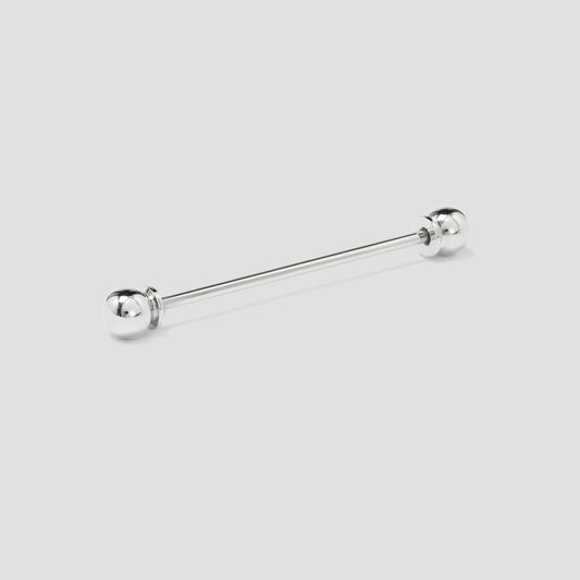 Silver barbell tie pin on a light gray background