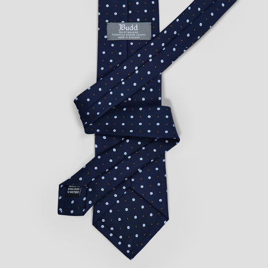 Hand-made navy silk tie featuring a blue and white double-dot motif, 8.5cm blade width, and elegant drape.