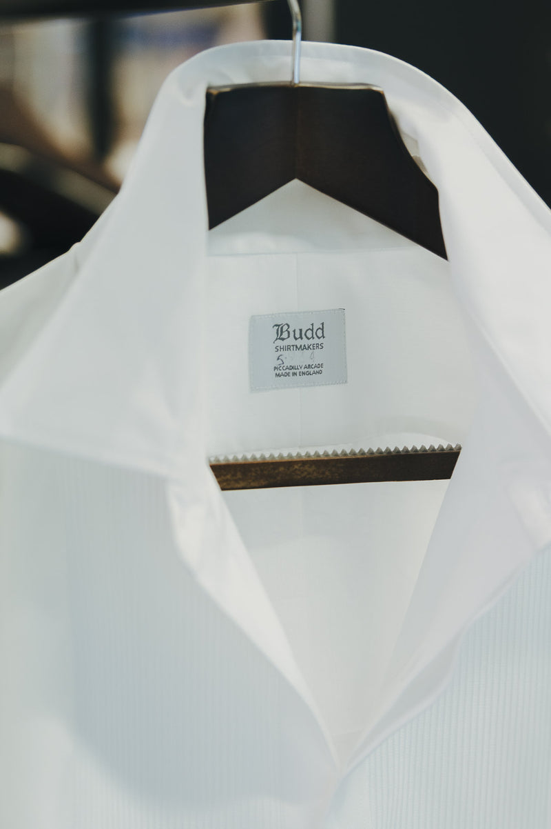 White shirt on a hanger with a visible brand label.
