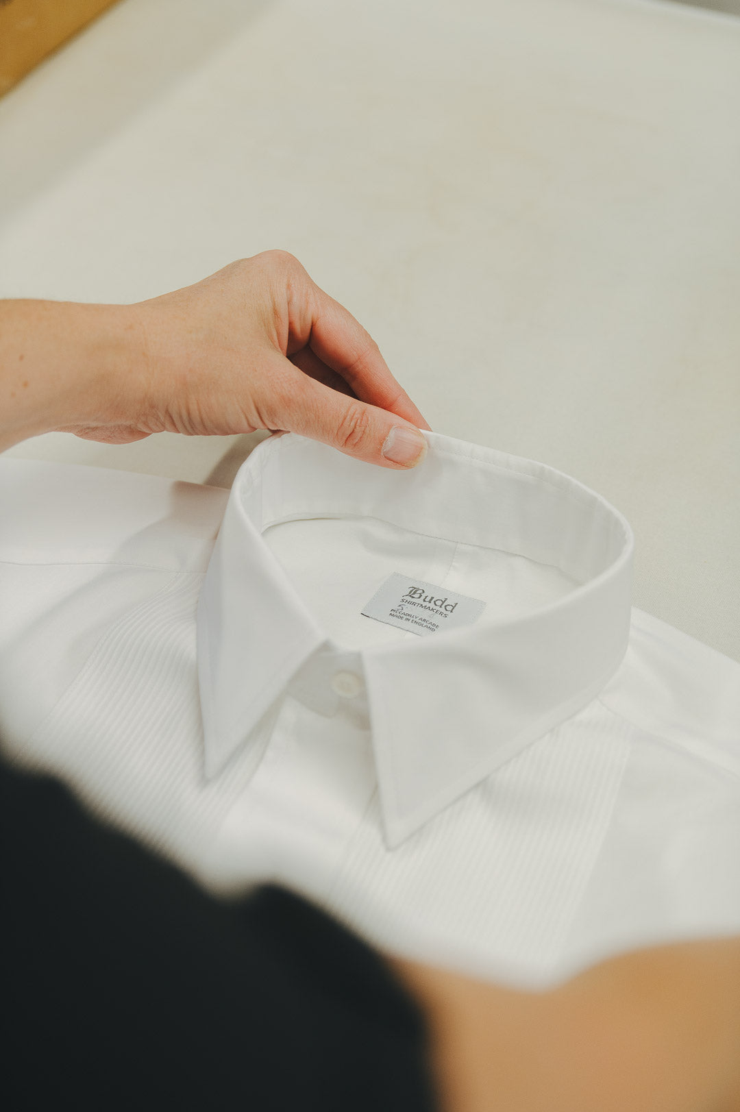 Budd white shirt being packed and folded