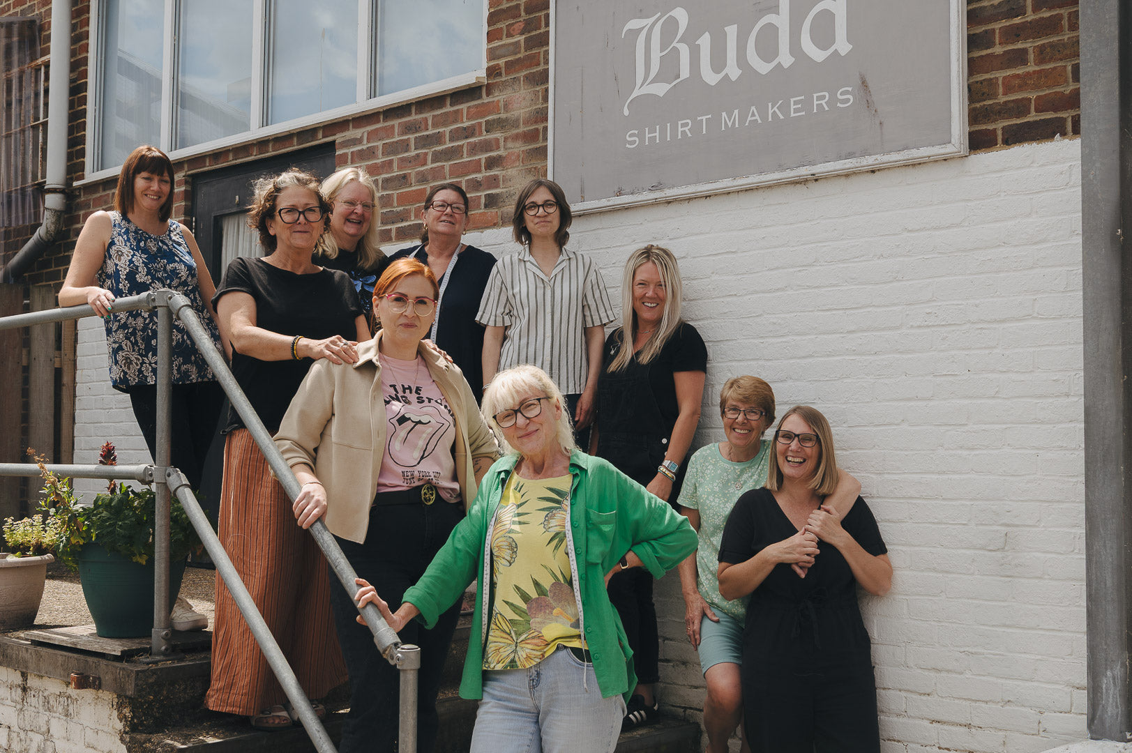 Group team photo stood outside Budd workroom in Andover