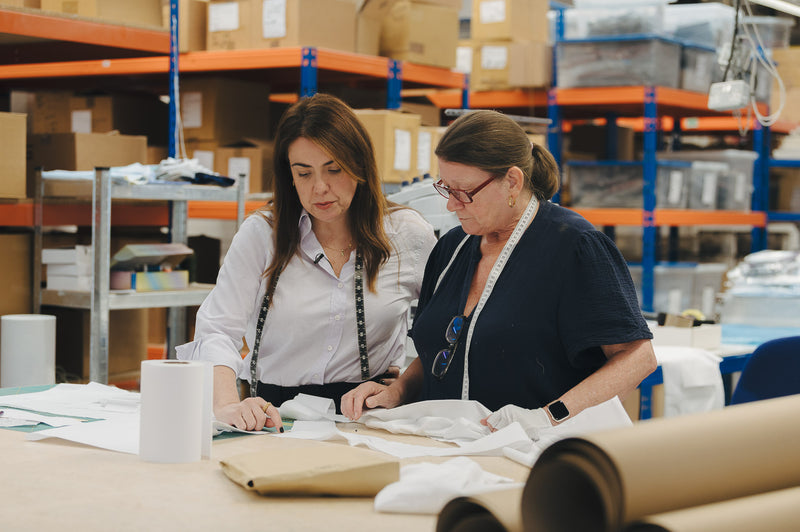 Shirt cutters in work room working with fabrics and pattern