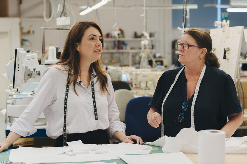 Shirt cutter in work room working with fabrics and pattern