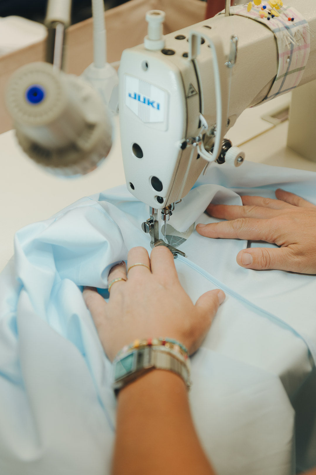 Person using a Juki sewing machine on fabric