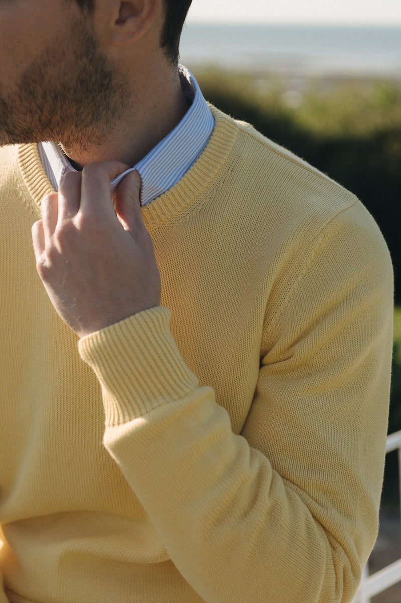 Close up of man wearing yellow sweater