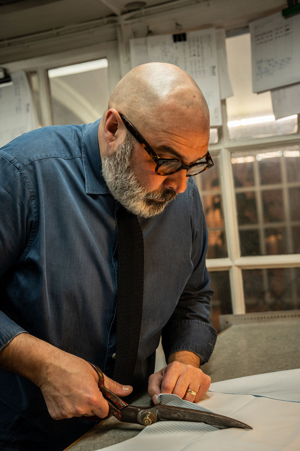 Man cutting a shirt in cutting room