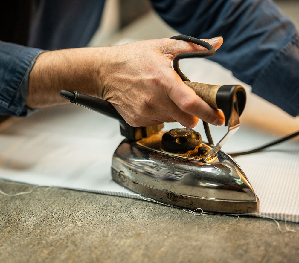Image of shirt cloth being pressed by silver iron
