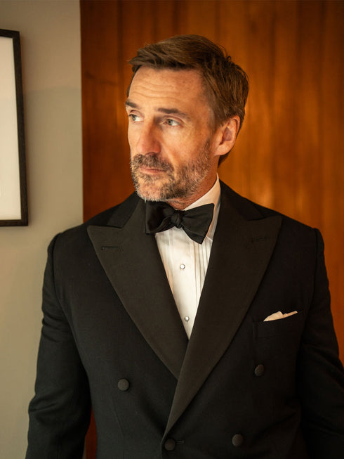 White pleated front dress shirt with black silk bow tie