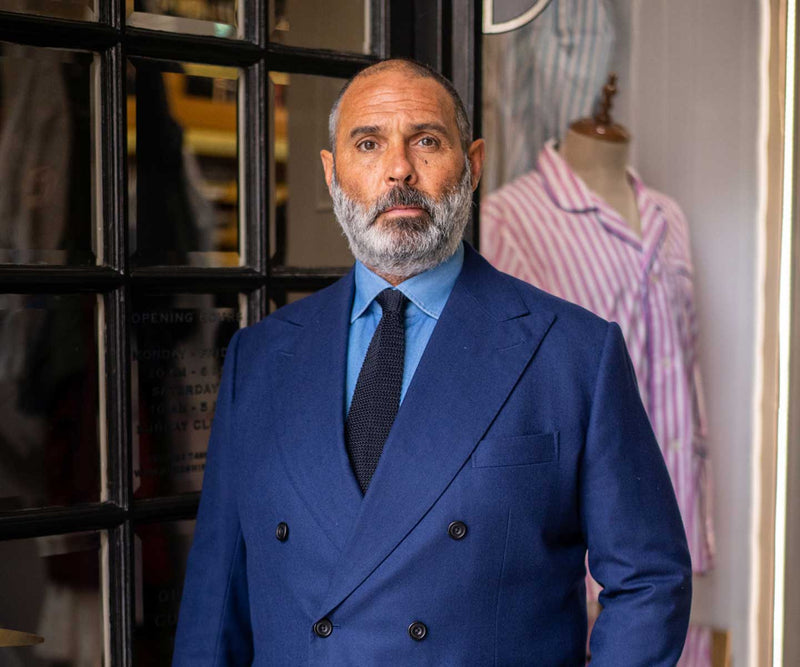 Budd shirtmakers cutter Darren stood outside the store wearing a blue suit