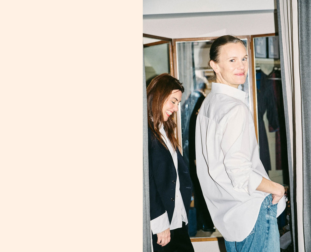 Author Jo Ellison standing in a room with mirrors reflecting their images.