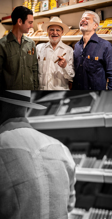 Three men in a store with shelves stocked with products, including cigars.