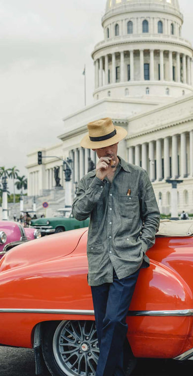 Kirby Allison in Havana street stood against vintage red car with pink car in background