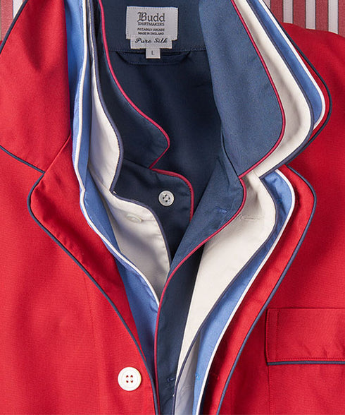 Collar detail of a stack of red, blue and white pyjamas laid inside each other
