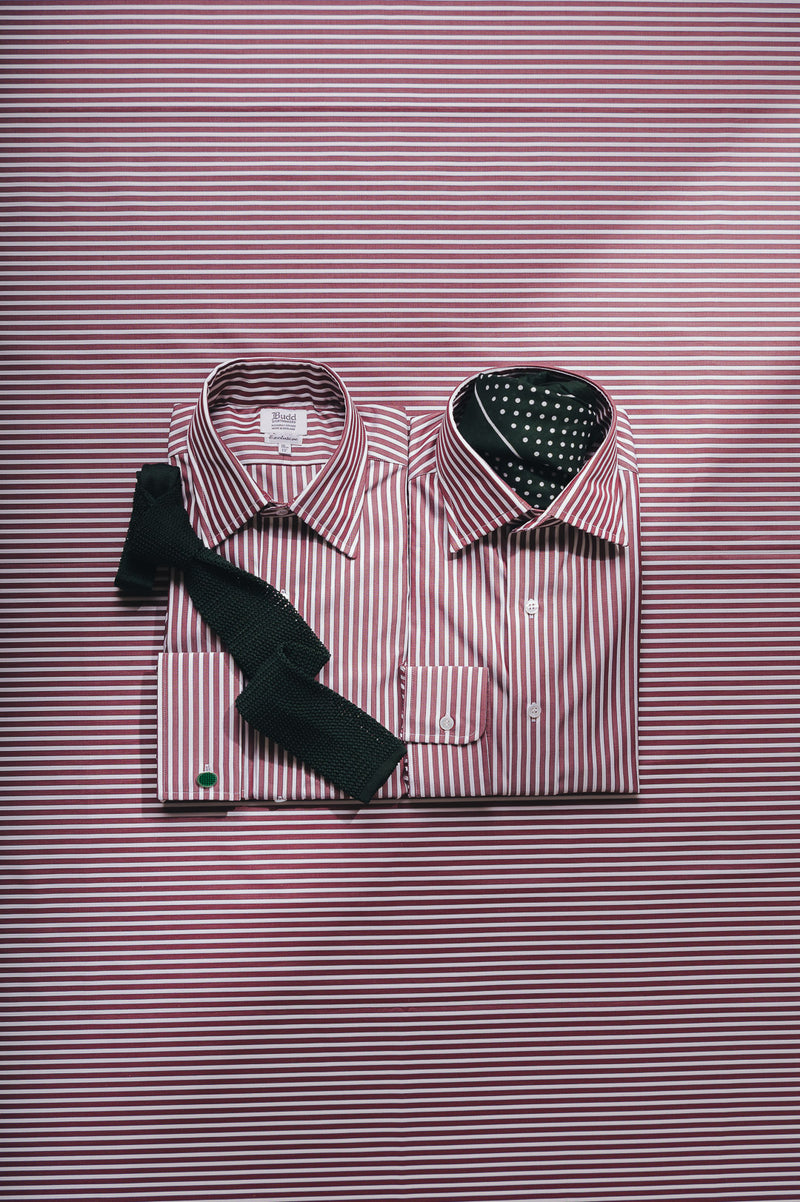 Striped shirt with a black tie on a striped background