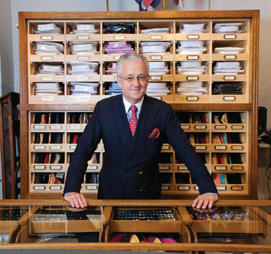 Sales Manager Andrew Rowley in front of the shop counter at Budd Shirtmakers in the Piccadilly Arcade