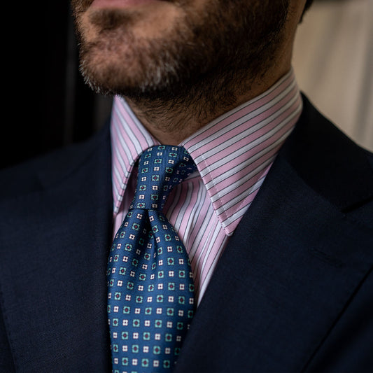 Collar detail of Budd stripe shirt in pale pink paired with blue patterned woven tie