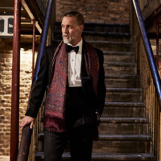 Model wearing marcella dress shirt with paisley silk scarf and black bow tie