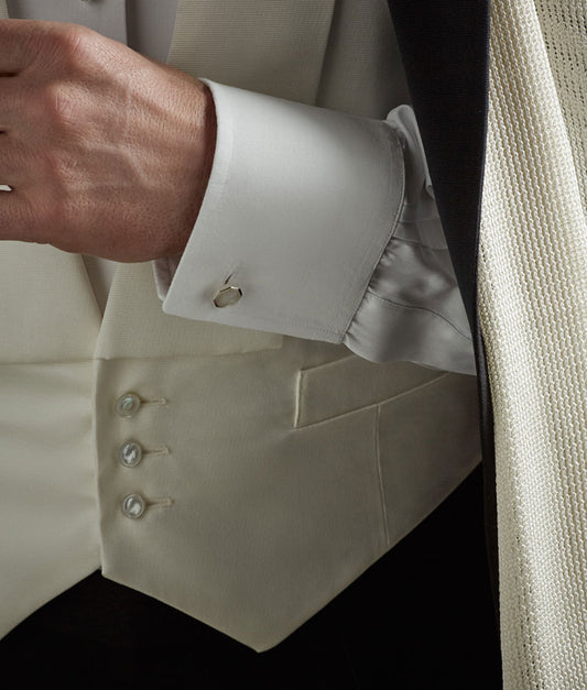 Close Up cuff shot of white double cuff shirt with cufflinks and white dress scarf with waistcoat for white tie attire